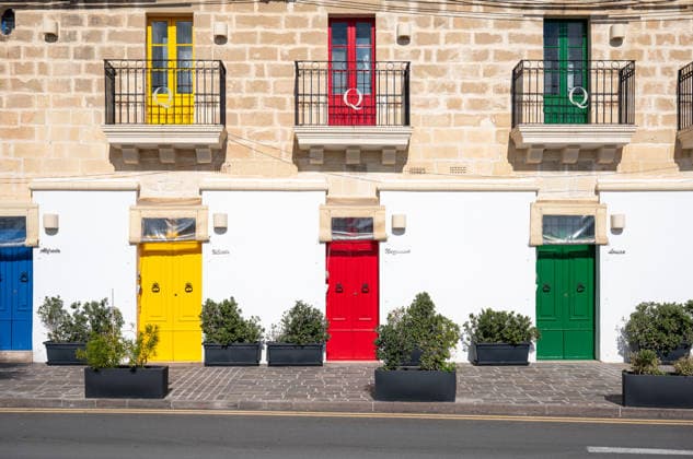 Colorful doors of traditional fishing houses along the coastal village of Marsaxlokk, showcasing authentic Maltese architecture and Mediterranean charm Marsaxlokk, Malta, 11 DEC 2025.