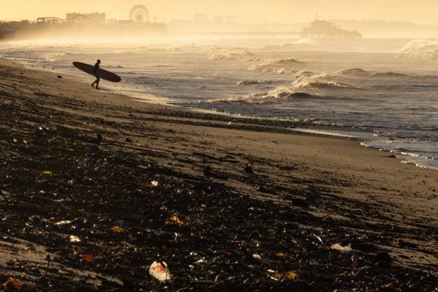 December 27, 2025, Los Angeles, California, USA: A surfer enters the Pacific Ocean at Will Rogers State Beach in Los Angeles as runoff debris, including material from the JanuaryÃ¢â‚¬â ¢s Palisades fire burn area, washes into the surf following heavy rain from a powerful three-day Pineapple Express storm system that brought record rainfall to Southern California. Los Angeles USA - ZUMAa01_ 20251227_zaf_a01_001 Copyright: xJonathanxAlcornx