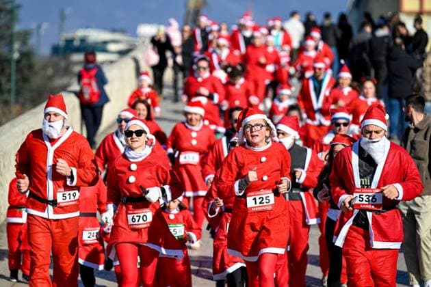 (251228) -- SKOPJE, Dec. 28, 2025 -- People dressed as Santa Claus participate in the traditional Santa race in Skopje, North Macedonia, Dec. 28, 2025. (Photo by Xinhua) NORTH MACEDONIA-SKOPJE-SANTA CLAUS-RACE TomislavxGeorgiev 