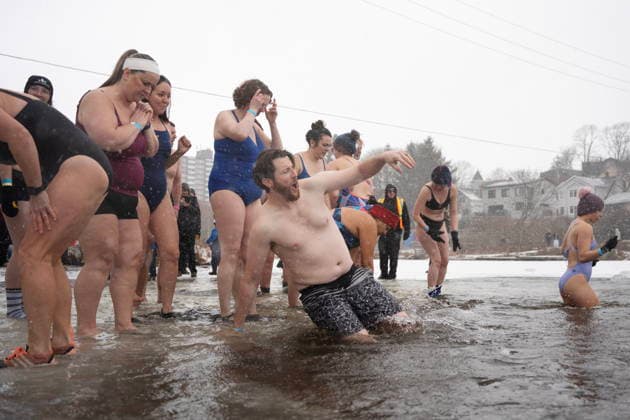 January 1, 2026, Dartmouth, Ns, Canada: People jump into the ice-filled water in Lake Banook during the annual polar bear swim on New Year s Day in Dartmouth, N.S., Thursday, Jan. 1, 2026. Dartmouth Canada  - ZUMAc35_ 20260101_zaf_c35_017 Copyright: xDarrenxCalabresex