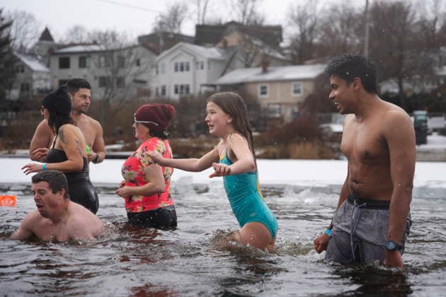 January 1, 2026, Dartmouth, Ns, Canada: People react to entering the ice-filled water in Lake Banook during the annual polar bear swim on New Year s Day in Dartmouth, N.S., Thursday, Jan. 1, 2026. Dartmouth Canada  - ZUMAc35_ 20260101_zaf_c35_019 Copyright: xDarrenxCalabresex