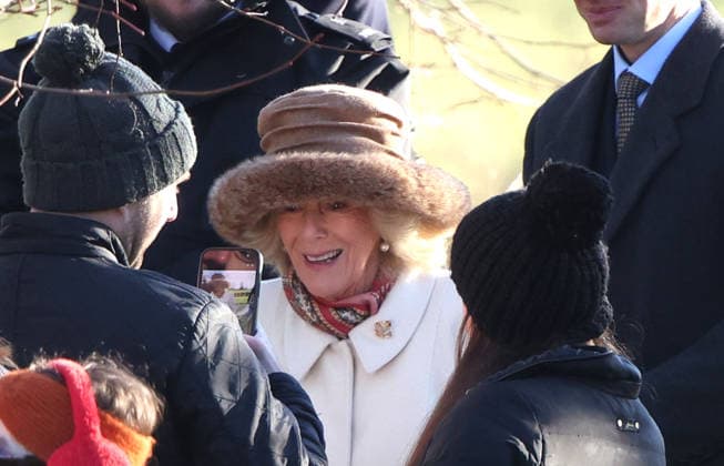 A person takes a picture of Queen Camilla. King Charles III and Queen Camilla, attended the Sunday morning service at St. Mary Magdalene church in Sandringham. King Charles III, Sandringham, Norfolk, on 4th January, 2026 