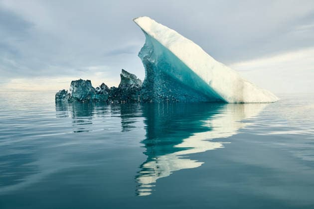 Reflecting Iceberg in Glacial Lagoon in Dramatic Light Vik, Mýrdalshreppur, Iceland CR_GASU260104-1929965-01