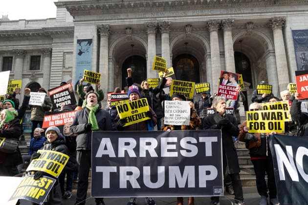 January 6, 2026, New York, New York, USA: Anti-Trump demonstrators mark the fifth anniversary of the January 6, 2021 insurrection with a protest on the steps of the Fifth Avenue branch of the New York Public Library in Midtown Manhattan. People chants and hold signs that read ARREST TRUMP IMPEACH. CONVICT. REMOVE. NO WAR on VENEZUELA NO WAR FOR OIL NO DICTATORS. Demonstrators with Rise and Resist denounce President Trump s acts as violations of Articles 1, 2, and 3, and Amendments 1, 4, 5, 10 and 14 of the Constitution. New York USA - ZUMAr174 20260106_znp_r174_002 Copyright: xGinaxMxRandazzox