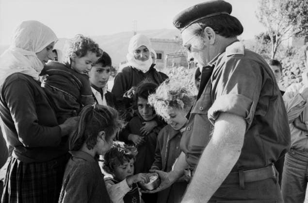 Ein israelischer Offizier verteilt während des Jom-Kippur-Krieges 1973 Süßigkeiten an Kinder in einem syrischen Dorf. Golan-Höhen Syrien *** a Israeli Officer distributed during of Jom KIPPUR War 1973 Sweets to Children in a Syrian Village Golan Heights Syria Copyright: xUnitedxArchivesx xSvenxSimonxArchives SVS_94010002377