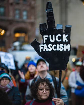 January 10, 2026, Chicago, Illinois, USA: Protester holding a handmade middle finger sign that reads Ã¢â‚¬ËœFuck FascismÃ¢â‚¬â ¢ in Downtown Chicago, during a rally in opposition to TrumpÃ¢â‚¬â ¢s War in Venezuela, and the killing of Renee Nicole Good by an ICE agent in Minneapolis. Chicago USA - ZUMAr170 20260110_znp_r170_007 Copyright: xChrisxRihax