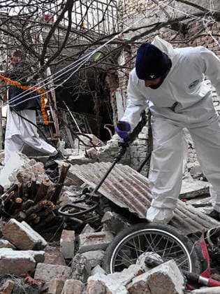 (260111) -- ISLAMABAD, Jan. 11, 2026 -- A security staff member examines the site of a gas explosion in Islamabad, capital of Pakistan on Jan. 11, 2026. The death toll from a gas explosion at a wedding house in Pakistan s federal capital, Islamabad, has risen to eight, including a newlywed couple, while 11 others were injured, local authorities said on Sunday. Rescue officials said at least four houses in the surrounding area were affected by the blast. Authorities said the exact cause of the explosion will be determined following a detailed investigation. (Str Xinhua) PAKISTAN-ISLAMABAD-GAS EXPLOSION-AFTERMATH AhmadxKamal 