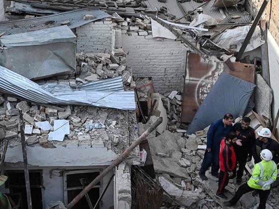 (260111) -- ISLAMABAD, Jan. 11, 2026 -- Security personnel examine the site of a gas explosion in Islamabad, capital of Pakistan on Jan. 11, 2026. The death toll from a gas explosion at a wedding house in Pakistan s federal capital, Islamabad, has risen to eight, including a newlywed couple, while 11 others were injured, local authorities said on Sunday. Rescue officials said at least four houses in the surrounding area were affected by the blast. Authorities said the exact cause of the explosion will be determined following a detailed investigation. (Str Xinhua) PAKISTAN-ISLAMABAD-GAS EXPLOSION-AFTERMATH AhmadxKamal 