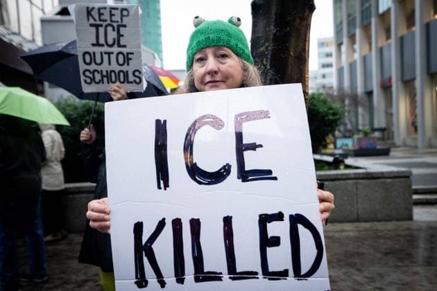 January 11, 2026, Vancouver, Bc, CANADA: A woman holds a sign to demonstrate during an Ice Out For Good rally outside of the U.S. Consulate General office in Vancouver, on Sunday, January 11, 2026. Vancouver CANADA  - ZUMAc35_ 20260111_zaf_c35_042 Copyright: xEthanxCairnsx