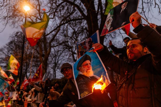 Iran Solidarity Protest, Iranian Embassy, London, UK. Iranian Embassy, London, UK. 12th January 2026. Protester holds a burning image of the Ayatollah, Ali Khamenei in one hand and the exiled Crown Prince of Iran, Reza Pahlavi in the other. Activists and members of the Iranian community in London have been gathering in front of the Iranian Embassy in support of the protests in Iran and against the Islamic Republic and Ayatollah., Credit:Photo by Amanda Rose Avalon United Kingdom, London, Knightsbridge, Embassy of the Islamic Republic of Iran  Copyright: xPhotoxbyxAmandaxRosex xAvalonx 1065486382