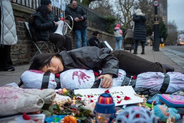 January 14, 2026, London, United Kingdom: A protester cuddles a wrapped human corpse which symbolises a victim who was killed by the Iranian regime. Hundreds of Iranian royalists gathered outside the Iranian Embassy in London, UK. Protesters want to show their support to the anti-government protesters in Iran. Demonstrators intend to replace the Supreme Leader of Iran, Ayatollah Ali Khamenei and his regime to the Crown Prince of Iran, Reza Pahlavi who lives in exile at the United States. London United Kingdom - ZUMAs197 20260114_aaa_s197_433 Copyright: xKrisztianxElekx
