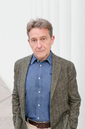 Man in a tweed jacket and denim shirt stands against a white wall with a serious expression. Italy atte03864 Copyright: xConnectxImagesx ,model released