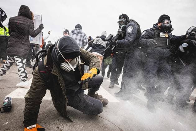 January 15, 2026, Minneapolis, Minnesota, USA: A protestor is pelted with pepper ball rounds as community members gather at the entrance of the Whipple Building in Minneapolis to rally in solidarity with their neighbors whom are being detained by U.S. ICE (Immigration and Customs Enforcement) agents. Minneapolis USA - ZUMAd256 20260115_znp_d256_005 Copyright: xDavexDeckerx