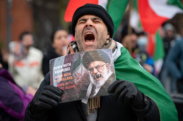 News Bilder des Tages Iranian diaspora protest outside US Embassy in London, UK - 16 Jan 2026 A protester chants slogans as he holds a poster with an image of Ali Khamenei, with vimpire fangs during the demonstration. Members of the Iranian diaspora gathered outside the US Embassy in London following recent anti-government protests in Iran, calling on US President Donald Trump to help bring an end to the Islamic Republic. Demonstrators urged support for regime change and voiced support for the return of Shah Pahlavi and the restoration of the monarchy, waving Iranian flags and chanting slogans against the current leadership in Tehran. London United Kingdom Copyright: xAndreaxDomeniconix xSOPAxImagesx ADOMENICONI_Z62_9274
