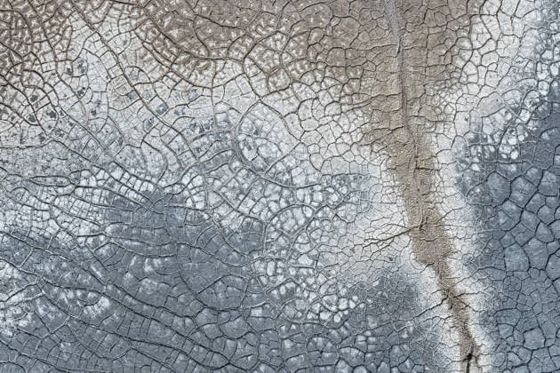 Cracked earth texture with natural saline patterns Close-up of a dried mud surface showcasing natural saline cracks and fissures. The intricate gray and beige texture forms an abstract, organic pattern. Model Released JuanLopez_ID32591_1110202_008 Copyright: xJuanxLopezx RECORD DATE NOT STATED