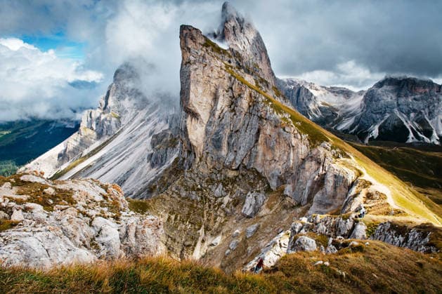 Creative Highlights World Seceda mountain in Dolomites, Italy, with clouds and hiking trail Urtijëi, Trentino-South Tyrol, Italy CR_JUCE260120-1947977-01