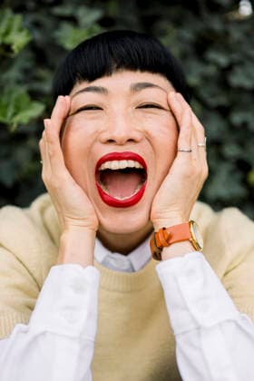 Portrait of joyful woman with red lipstick smiling outdoors model released, Symbolfoto, FLMZF02038
