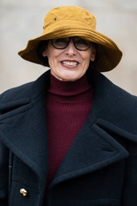 PFW - Patou Arrivals Inès de la Fressange wears red turtleneck sweater, black pants, black cropped coat, yellow bucket hat, outside Patou Menswear Fall Winter 2026-2027 show as part of Paris Fashion Week on January 25, 2026 in Paris, France. Photo by LounisPhotography ABACAPRESS.COM Paris France  Copyright: xLounisPhotography ABACAx