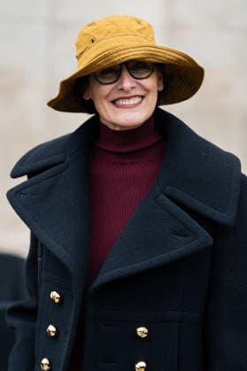 PFW - Patou Arrivals Inès de la Fressange wears red turtleneck sweater, black pants, black cropped coat, yellow bucket hat, outside Patou Menswear Fall Winter 2026-2027 show as part of Paris Fashion Week on January 25, 2026 in Paris, France. Photo by LounisPhotography ABACAPRESS.COM Paris France  Copyright: xLounisPhotography ABACAx