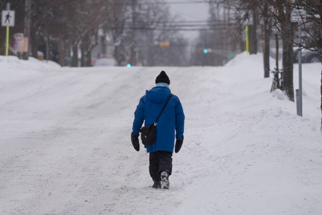 January 26, 2026, Halifax, Ns, Canada: A pedestrian walks down a snow-covered street during a winter storm that closed schools and delayed travel in Halifax on Monday, Jan. 26, 2026. Severe cold weather warnings and snowfall warnings have remained in place across Atlantic Canada. Halifax Canada  - ZUMAc35_ 20260126_zaf_c35_001 Copyright: xDarrenxCalabresex