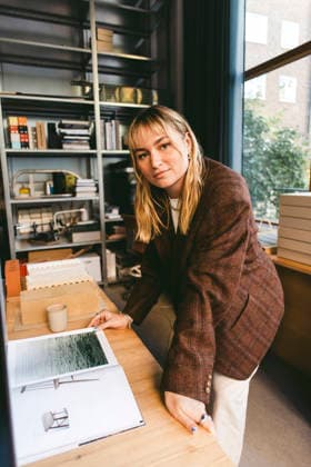 High angle portrait of confident young female architect leaning on desk in new office Sweden, Stockholm, model released, property released Copyright: xMaskotx , MA123036 MA123036