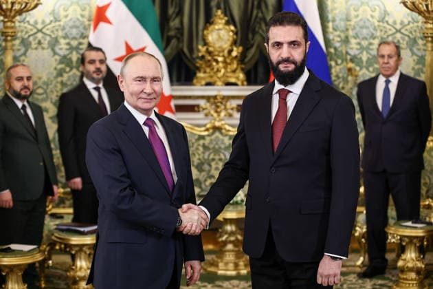 RUSSIA, MOSCOW - JANUARY 28, 2026: Vladimir Putin (L), President of Russia, and his Syrian interim counterpart Ahmed al-Sharaa shake hands during a meeting at the Moscow Kremlin. Mikhail Tereshchenko TASS  87922584