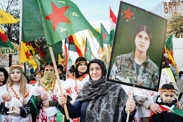 Rally in support of the Revolution in Rojava - Toulouse Rally in support of International Solidarity for Rojava asking action against the massacre of the Kurds, in Toulouse, France, on January 31, 2026. A woman in the foreground, Ms. Atac, holding the YPJ flag, Women s Protection Units, in one hand and a poster of a female warrior in the other, with women behind her wearing white dresses stained with blood on their hands, some with babies in their arms. Rally in support of the revolution in Rojava, a semi-autonomous region in northeastern Syria, which is under attack by the new regime seeking to extend its authority over Kurdish-administered territories. Photo by Patricia Huchot-Boissier ABACAPRESS.COM TOULOUSE OCCITANIE France  Copyright: xHuchot-BoissierxPatricia ABACAx