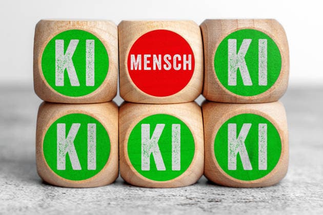 Bavaria, Germany - February 2, 2026: PHOTOMONTAGE, wooden cubes labeled Human? and AI? symbolize the contrast and relationship between human responsibility and artificial intelligence in a digital future. *** FOTOMONTAGE, Holzwürfel mit der Aufschrift Mensch und KI symbolisieren den Gegensatz und die Beziehung zwischen menschlicher Verantwortung und künstlicher Intelligenz in einer digitalen Zukunft.