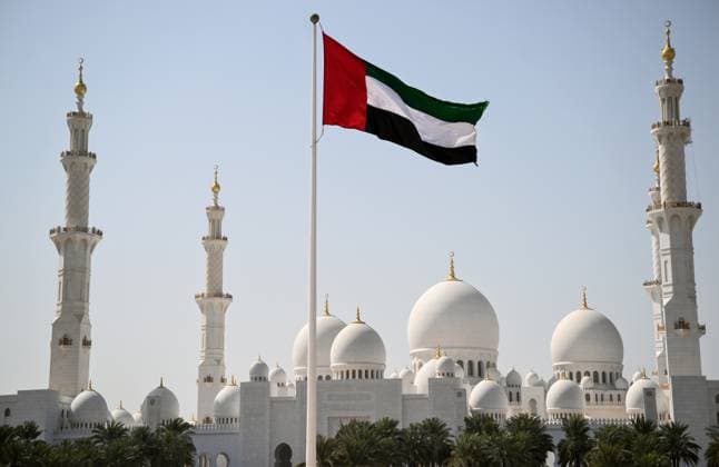UAE Russia US Ukraine Negotiations 9098682 04.02.2026 A national flag of the United Arab Emirates flies in front of the Sheikh Zayed Mosque in Abu Dhabi, United Arab Emirates. The second round of U.S.-brokered talks between Russia and Ukraine started in the capital of the UAE on February 4. Kirill Zykov Sputnik Abu Dhabi United Arab Emirates  Copyright: xKirillxZykovx