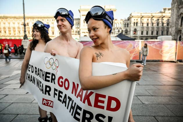 February 5, 2026, Milan, Mi, Italy: February 5, 2026, Milan. Piazza Duomo. Better Naked Than Wear Feathers, PETA s protest before the Olympics. A trio of nearly naked PETA supportersÃ¢â‚¬wearing only hats, ski goggles, and snow bootsÃ¢â‚¬stand behind a banner reading We d Rather Go Naked Than Wear Feathers! Milan Italy  - ZUMAa289 20260205_zia_a289_199 Copyright: xNicolaxMarfisix