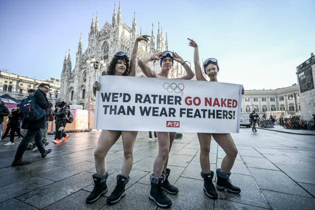 PETA protests We d Rather go naked than wear feathers! before the Olympics. February 5, 2026, Milan. Piazza Duomo. Better Naked Than Wear Feathers, PETA s protest before the Olympics. A trio of nearly naked PETA supporters wearing only hats, ski goggles, and snow boots stand behind a banner reading We d Rather Go Naked Than Wear Feathers! , Credit:Nicola Marfisi Avalon Italy, MI, Milan  Copyright: xNicolaxMarfisix xAvalonx 1072326713