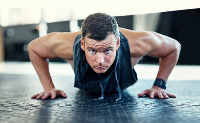 Portrait, man and push ups workout in gym for functional fitness, core stability and intense challenge. Active, athlete or bodyweight exercise at health club for endurance, strength training or power. model released property released Copyright: xPeopleImages.comx-x 1599518x