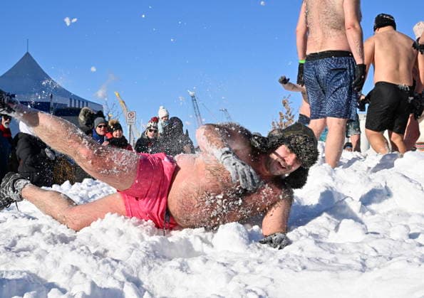 February 8, 2026, Quebec, Pq, Canada: A snow bather rolls in the snow during the annual snow bath at the Quebec winter carnival in Quebec City Sunday, Feb. 8, 2026. Quebec Canada  - ZUMAc35_ 20260208_zaf_c35_214 Copyright: xJacquesxBoissinotx