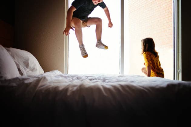 Two Children Jumping on Bed in Window Light Tulsa, Oklahoma, United States CR_KRRY260210-1958429-01 ,model released, Symbolfoto