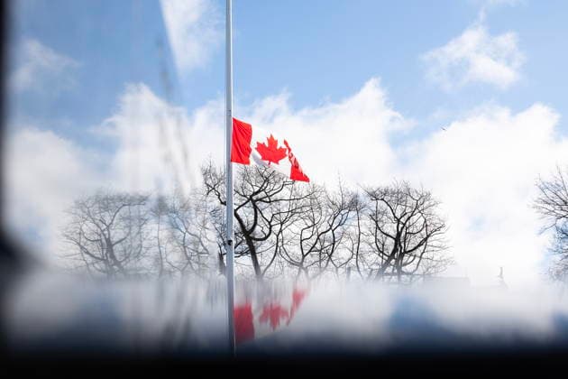 February 11, 2026, Victoria, Bc, CAN: The sky and clouds are reflected off of the Queen Victoria statue as the Canadian flag hangs at half-mast at the legislature in Victoria, B.C., on Wednesday, Feb. 11, 2026 in honour of the victims in the mass shooting in Tumbler Ridge, B.C. Victoria CAN  - ZUMAc35_ 20260211_zaf_c35_201 Copyright: xChadxHipolitox
