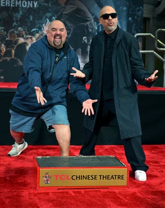 Jo Koy (R) and Gabriel Iglesias ham it up for photographers at a hand and footprint ceremony honoring Koy in the forecourt of the TCL Chinese Theatre in Los Angeles, California on Wednesday, February 11, 2026.  LAP20260211703 CHRISxCHEW