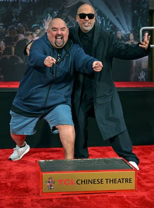 Jo Koy (R) and Gabriel Iglesias ham it up for photographers at a hand and footprint ceremony honoring Koy in the forecourt of the TCL Chinese Theatre in Los Angeles, California on Wednesday, February 11, 2026.  LAP20260211705 CHRISxCHEW