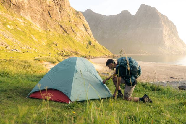 MR_ID32524_23616_IoritzLopez.jpg, MR_ID32524_23617_ArgineSatrustegui.jpg A hiker sets up a tent in the stunning Lofoten Islands, surrounded by majestic mountains and serene beaches, capturing the essence of a thrilling camping adventure. Model Released IoritzLopez_ID32524_1108276_058 Copyright: xIoritzxLopezx RECORD DATE NOT STATED