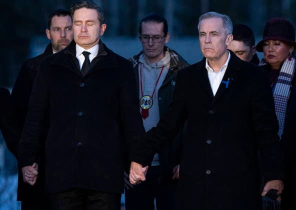 February 13, 2026, Tumbler Ridge, Bc, CANADA: Prime Minister Mark Carney, right, and Conservative Leader Pierre Poilievre join hands while attending a vigil for the victims of a mass shooting, in Tumbler Ridge, B.C., Friday, Feb. 13, 2026. Tumbler Ridge CANADA - ZUMAc35_ 20260213_zaf_c35_184 Copyright: xChristinnexMuschix