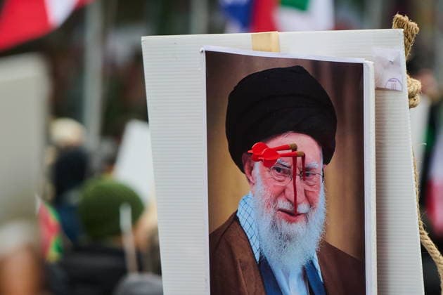 February 14, 2026, Toronto, On, Canada: Protesters carry a sign with Iranian Supreme Leader Ali Khamenei perforated by darts as they march in support of regime change in Iran during a demonstration in Toronto, on Saturday, Feb. 14, 2026. Toronto Canada  - ZUMAc35_ 20260214_zaf_c35_207 Copyright: xSammyxKoganx