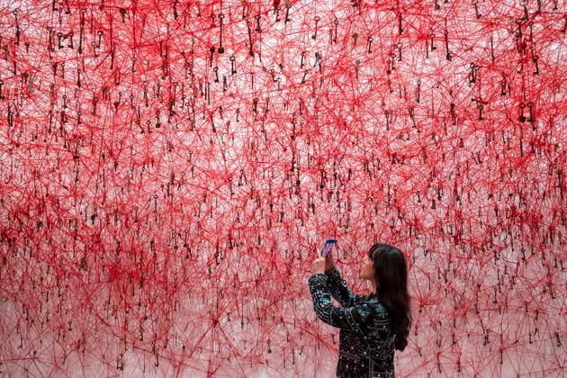 February 16, 2026, London, UK: A staff member during the Threads of Life preview of Chiharu Shiota: Threads of Life, a new exhibition by Japanese performance and installation artist Chiharu Shiota at the Hayward Gallery, presenting her iconic floor-to-ceiling weblike works made of red, white and black thread. The show runs from 17 February to 3 May 2026. London UK  - ZUMAl94_ 20260216_zaf_l94_007 Copyright: xStephenxChungx