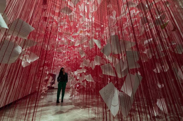 February 16, 2026, London, England, United Kingdom: A staff member looks at Letters of Thanks , 2026, by Chiharu Shiota during a photocall at the Hayward Gallery ahead of the first major solo London exhibition titled Threads of Life of the Berlin-based Japanese artist. London United Kingdom - ZUMAs371 20260216_zip_s371_020 Copyright: xWiktorxSzymanowiczx