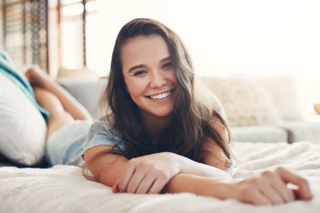 Relax, happy and portrait with woman on sofa of house for calm, comfortable and free time. Smile, weekend break and peace with person resting in living room of apartment for chill and lounge. model released property released Copyright: xx