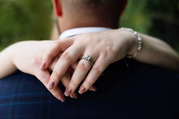 Bride Showing Engagement Ring While Embracing Groom Cancún, Quintana Roo, Mexico R_LTRZ260216-1963264-01