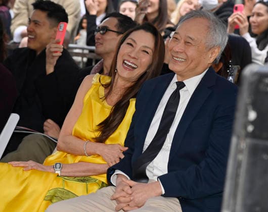 Actress Michelle Yeoh (L) and director And Lee react to comments during an unveiling ceremony honoring her with the 2,836th star on the Hollywood Walk of Fame in Los Angeles on Wednesday, February 18, 2026.  LAP2026021825 JIMxRUYMEN