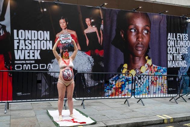 February 19, 2026, London, London, UK: LONDON, UK. A heavily pregnant woman, with a painting of a gestating cow on her belly, pours fake blood over herself during a protest by PETA, People for the Ethical Treatment of Animals, outside 180 Strand on the opening day of London Fashion Week. PETA is protesting against the use of leather products in the fashion industry and demands that consumers switch to vegan-based goods. London UK  - ZUMAl94_ 20260219_zaf_l94_020 Copyright: xStephenxChungx