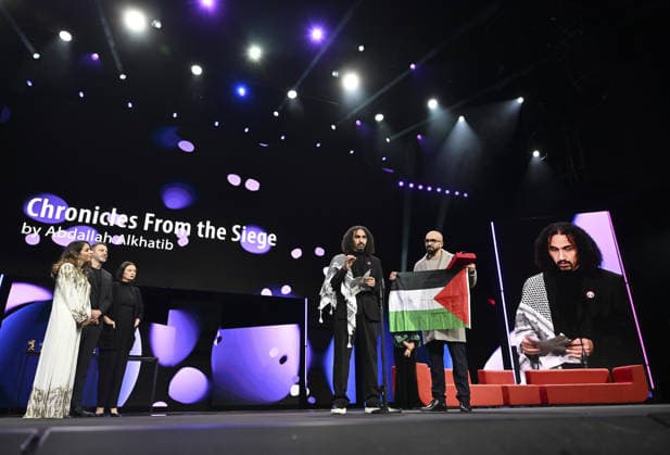 76th Berlin International Film Festival BERLIN, GERMANY - FEBRUARY 21: Director Abdallah Alkhatib (2nd R) takes to the stage carrying the Palestinian flag after winning the Best Feature Film Award with his film Chronicles From the Siege at the 76th Berlin International Film Festival (Berlinale) in Berlin, Germany, on February 21, 2026. Halil Sagirkaya Anadolu Berlin Germany. Editorial use only. Please get in touch for any other usage.  Copyright: x2026xAnadoluxHalilxSagirkayax