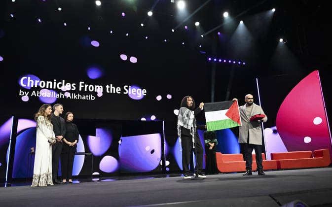 76th Berlin International Film Festival BERLIN, GERMANY - FEBRUARY 21: Director Abdallah Alkhatib (2nd R) takes to the stage carrying the Palestinian flag after winning the Best Feature Film Award with his film Chronicles From the Siege at the 76th Berlin International Film Festival (Berlinale) in Berlin, Germany, on February 21, 2026. Halil Sagirkaya Anadolu Berlin Germany. Editorial use only. Please get in touch for any other usage.  Copyright: x2026xAnadoluxHalilxSagirkayax
