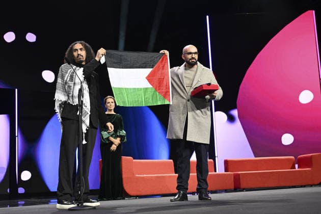76th Berlin International Film Festival BERLIN, GERMANY - FEBRUARY 21: Director Abdallah Alkhatib (L) takes to the stage carrying the Palestinian flag after winning the Best Feature Film Award with his film Chronicles From the Siege at the 76th Berlin International Film Festival (Berlinale) in Berlin, Germany, on February 21, 2026. Halil Sagirkaya Anadolu Berlin Germany. Editorial use only. Please get in touch for any other usage.  Copyright: x2026xAnadoluxHalilxSagirkayax