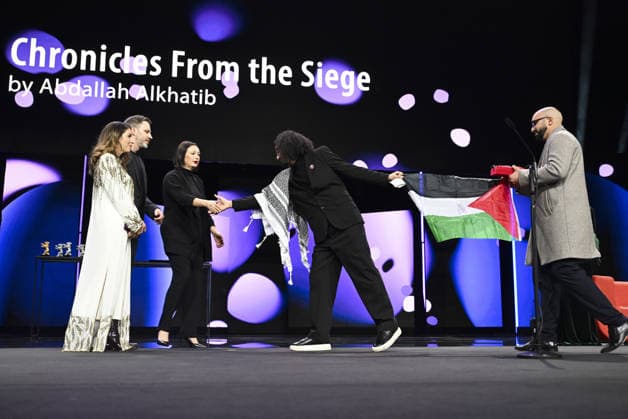 76th Berlin International Film Festival BERLIN, GERMANY - FEBRUARY 21: Director Abdallah Alkhatib (2nd R) takes to the stage carrying the Palestinian flag after winning the Best Feature Film Award with his film Chronicles From the Siege at the 76th Berlin International Film Festival (Berlinale) in Berlin, Germany, on February 21, 2026. Halil Sagirkaya Anadolu Berlin Germany. Editorial use only. Please get in touch for any other usage.  Copyright: x2026xAnadoluxHalilxSagirkayax